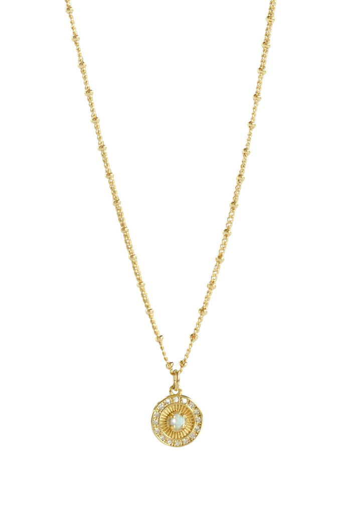 Shine bright with the Pixie Opal Coin Necklace—crafted in 18k Gold Filled and set on a tiny coin, this radiant piece adds effortless elegance to your everyday style.