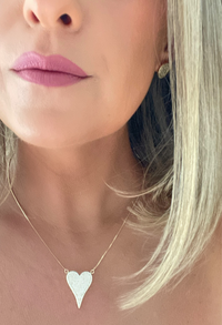 Elongated heart-shaped pendant adorned with sparkling cubic zirconia crystals, hanging from a delicate 18k gold-filled chain by Dylan Rae Jewelry.