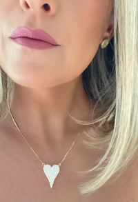 Elongated heart-shaped pendant adorned with sparkling cubic zirconia crystals, hanging from a delicate 18k gold-filled chain by Dylan Rae Jewelry.