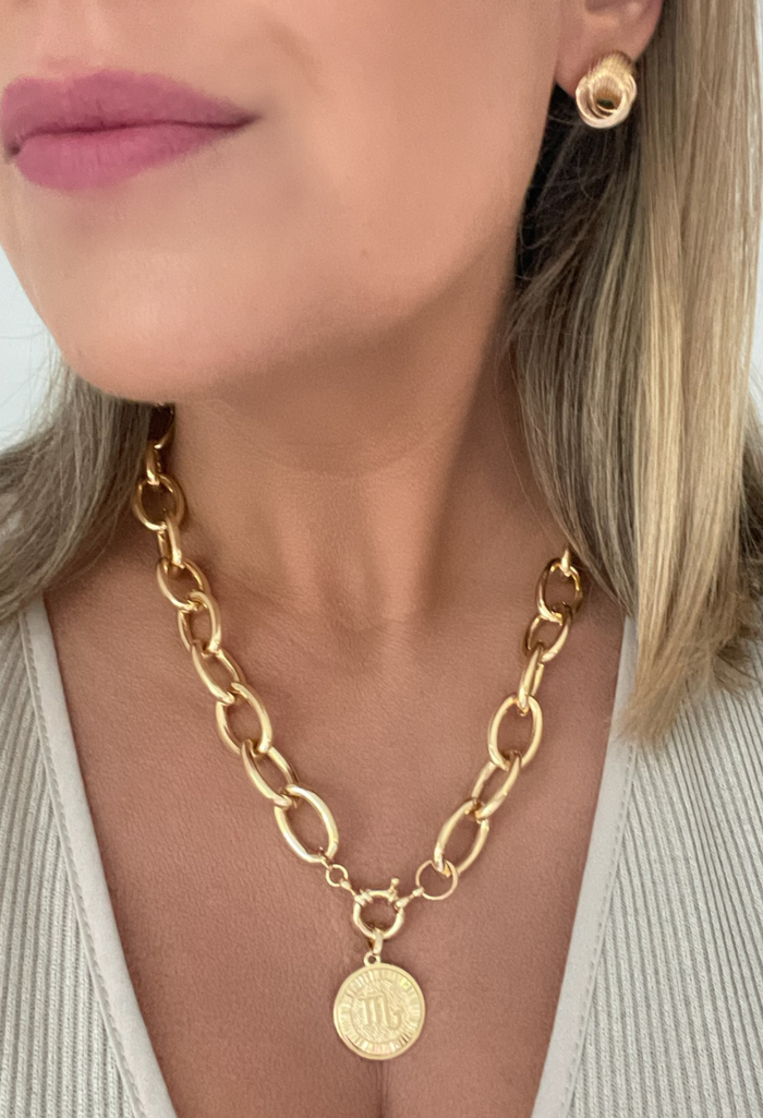 Elevate your everyday look with our Chunky Rolo Chain featuring a stunning zodiac coin. Crafted in 18k gold fill, this necklace is designed for the modern woman who loves versatile, statement pieces. Whether worn alone for a sleek, bold vibe or layered with your favorite chains, it’s the perfect blend of personal and chic.