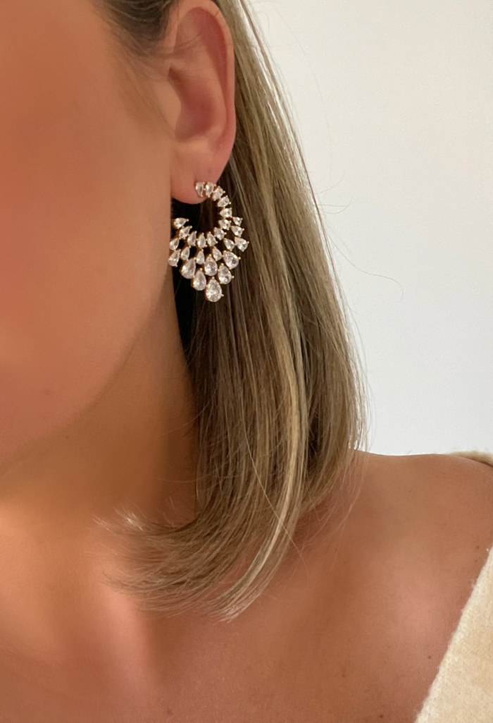 Our Sunburst Earrings dazzle with gold-filled elegance and sparkling cubic zirconia, perfect for making any occasion unforgettable. With each crystal catching the light, they bring a radiant, festive charm to your entire look.