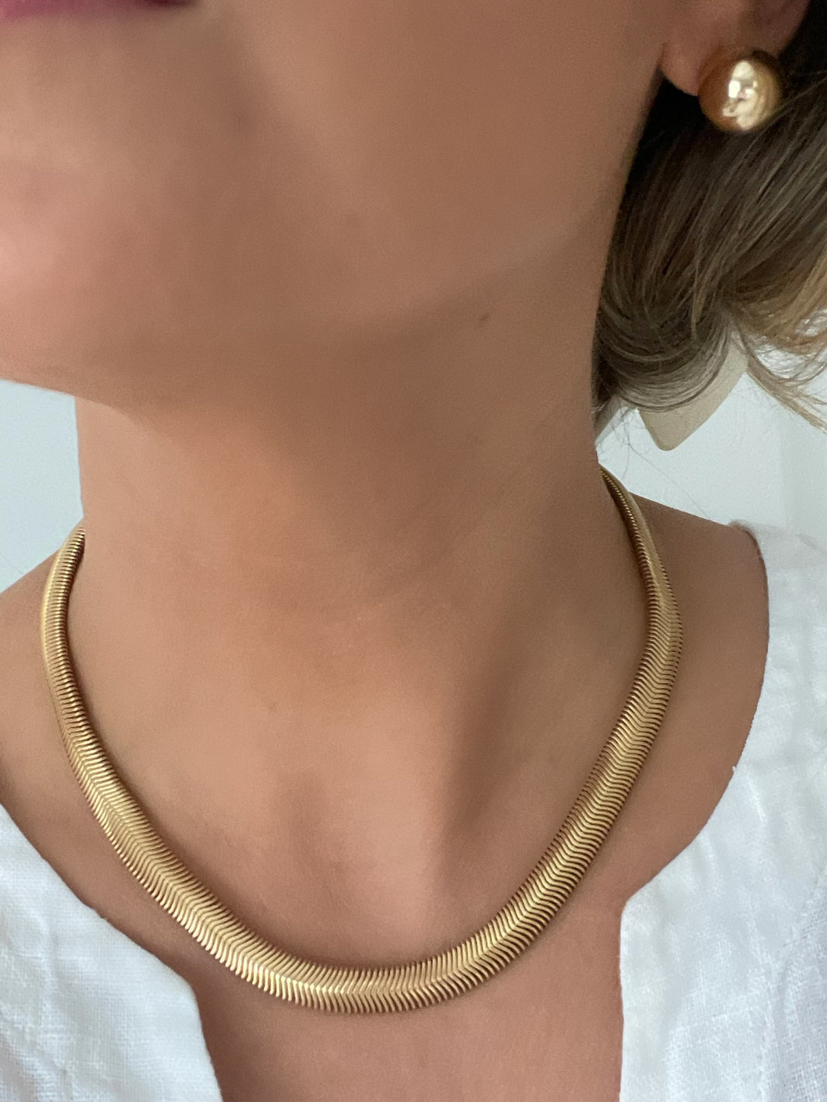 The Slinky Snake Herringbone Chain by Dylan Rae Jewelry, showcasing its elegant 18k gold-filled design.