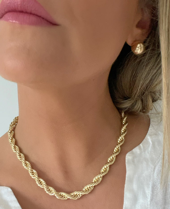 Stunning model wearing our 7mm Gold Rope Chain, highlighting its statement-making design and luxurious 18k gold filled material.