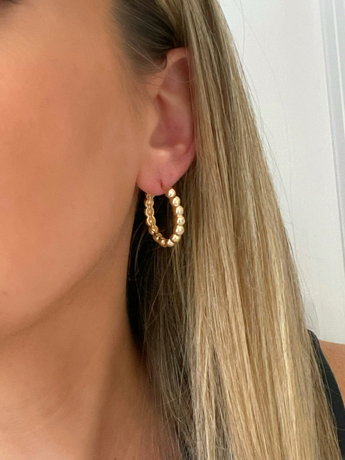 Handcrafted gold hoop earrings with intricate beaded detailing by Dylan Rae Jewelry