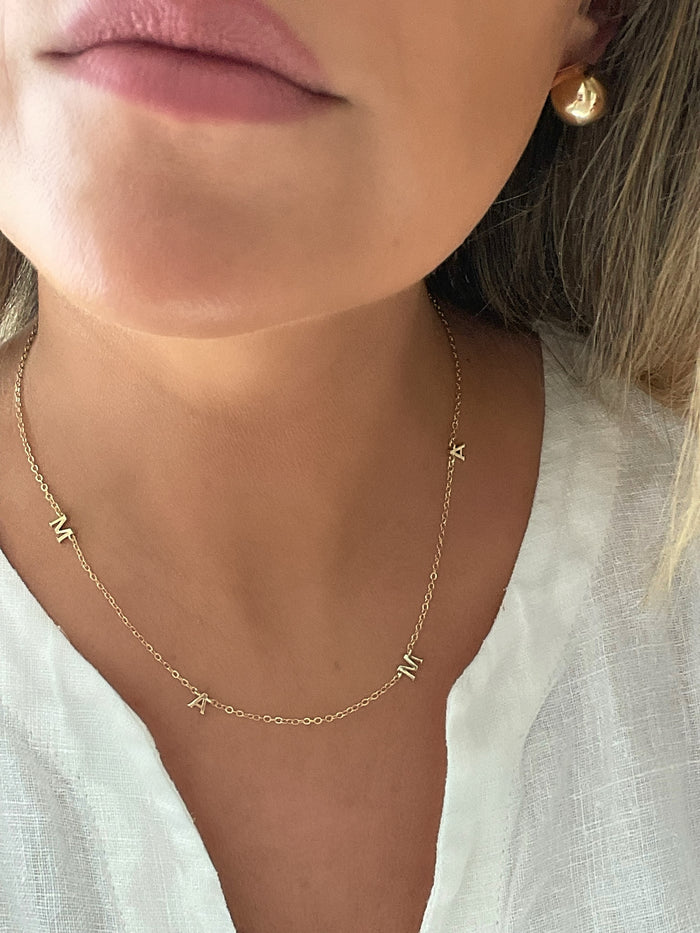 Gold necklace with 'mama' pendant, a heartfelt tribute to motherhood by Dylan Rae Jewelry