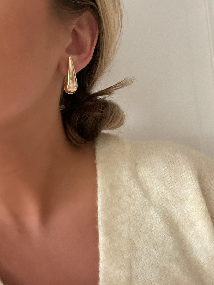 Sleek gold teardrop earrings from the Luna Raindrop Collection, showcasing modern elegance and sophistication.