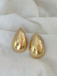 Oversized teardrop gold statement earrings, dipped in 18k gold for maximum impact and style.