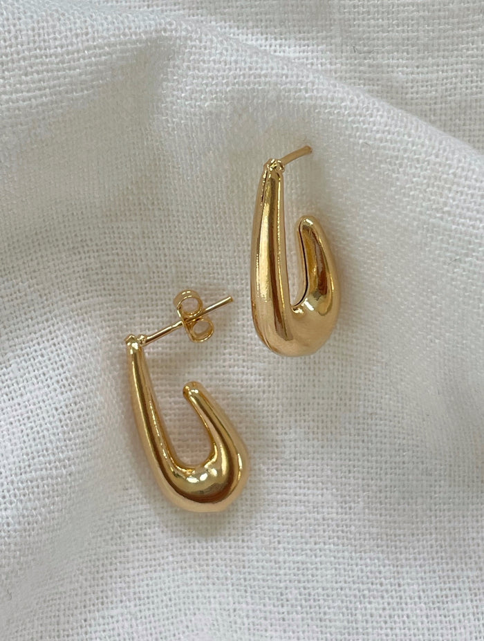 Lightweight tear drop gold earrings with a tapered silhouette, perfect for everyday chic.