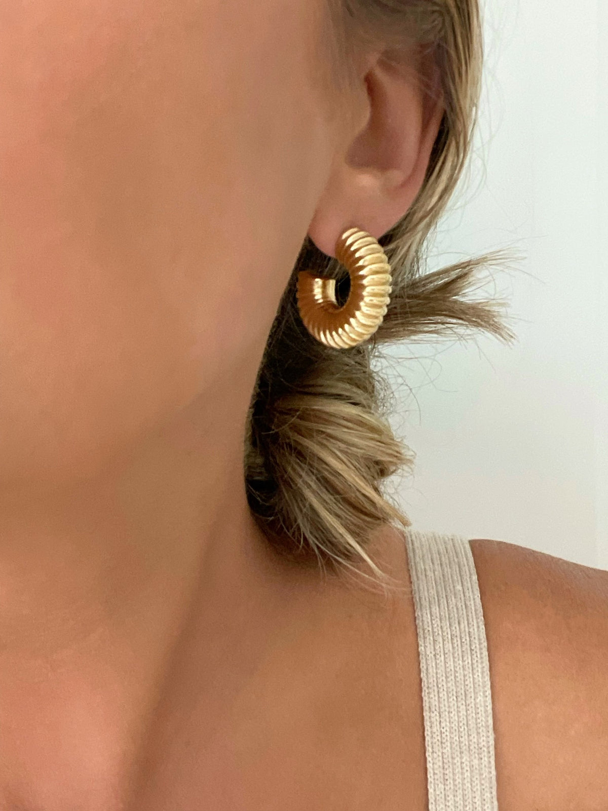 Chunky gold hoop earrings with ribbed texture, by Dylan Rae Jewelry