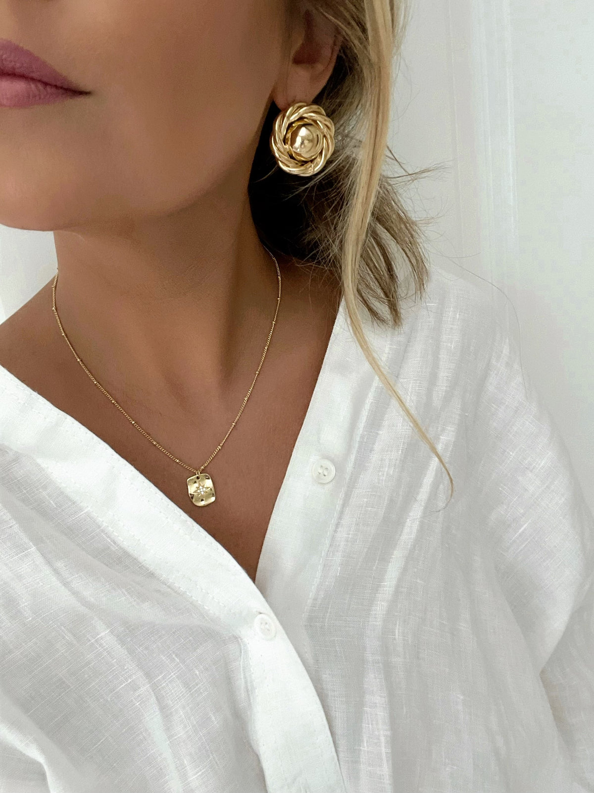Vintage-inspired gold button earrings with twisted border design, showcasing timeless elegance for modern women.